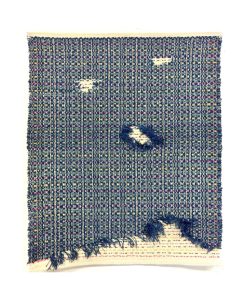 a handwoven scarf with doubleweave, showing areas of decay on purpose